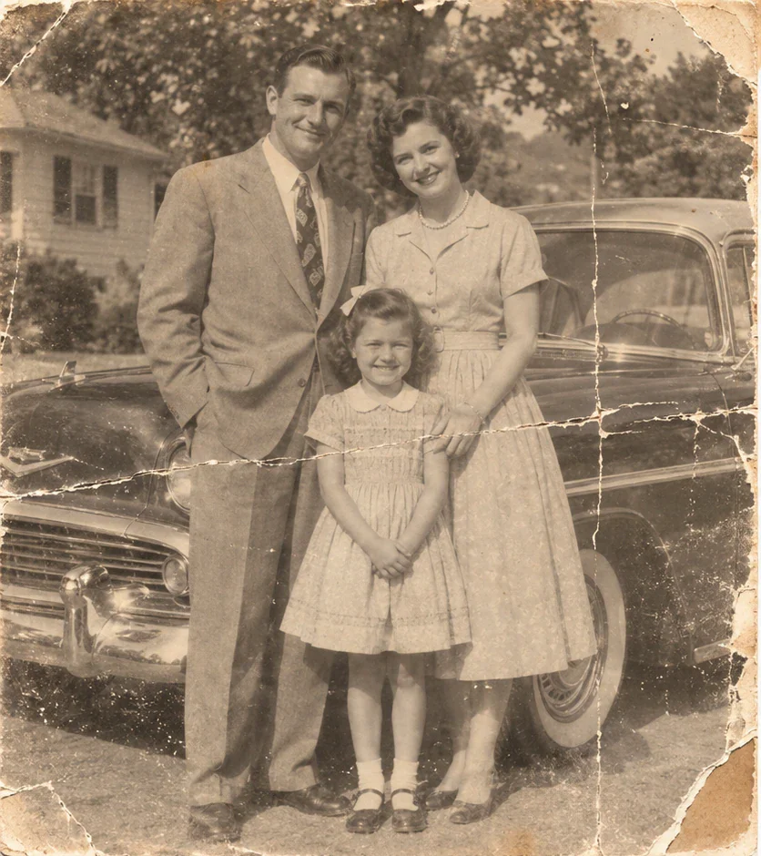 Damaged original 1950s family photograph showing the man, woman, girl, house, and automobile